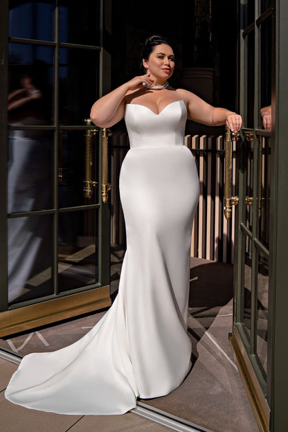 Off shoulder satin bridal gown for curvy bride with a classic silhouette