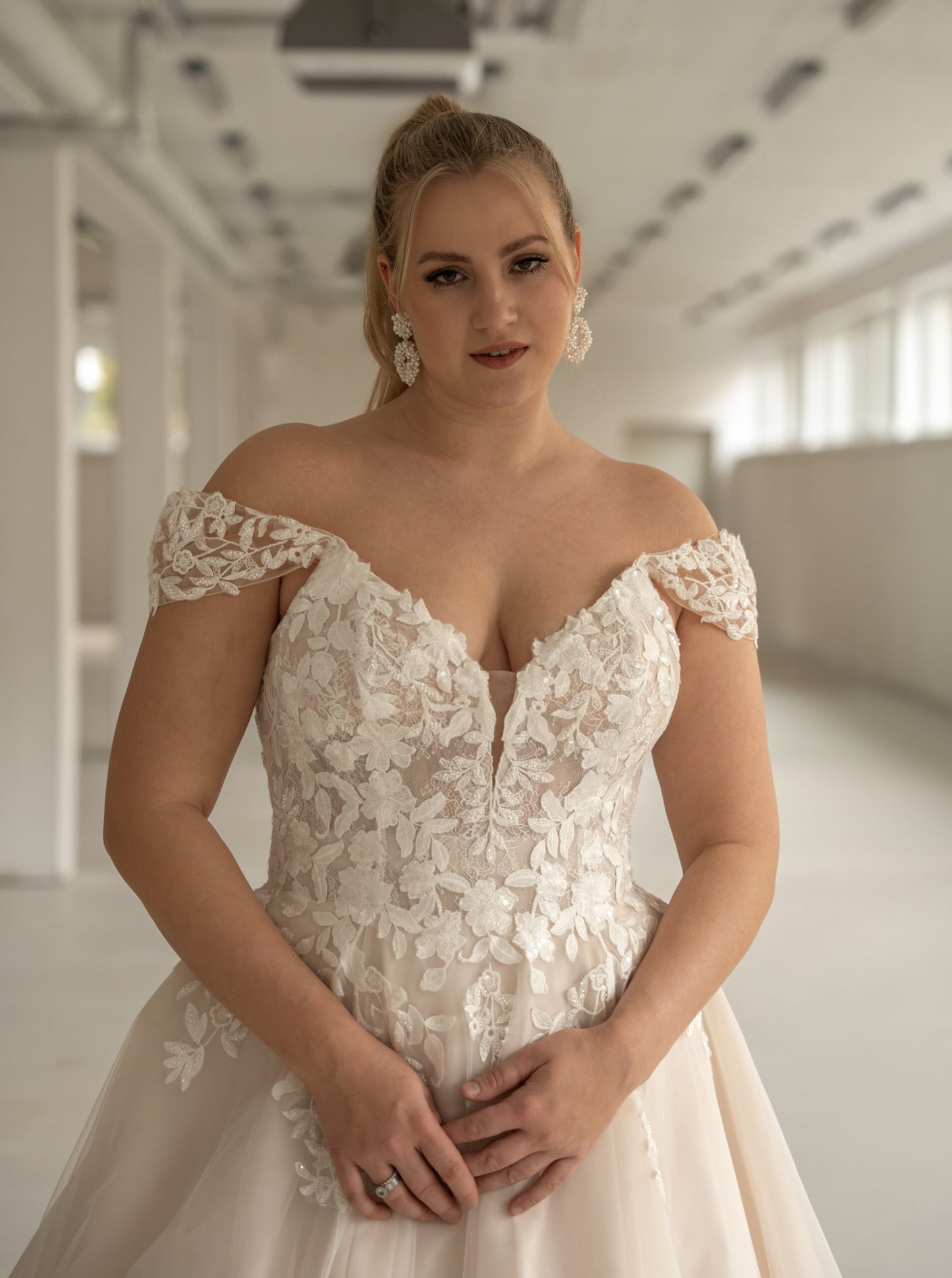 Flowing train and floral lace hem of A-line wedding dress