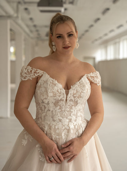 Flowing train and floral lace hem of A-line wedding dress
