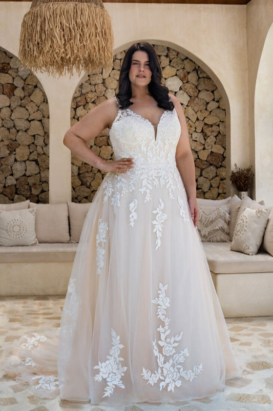 Plus size boho A-line wedding dress with floral appliqué and flowy tulle skirt