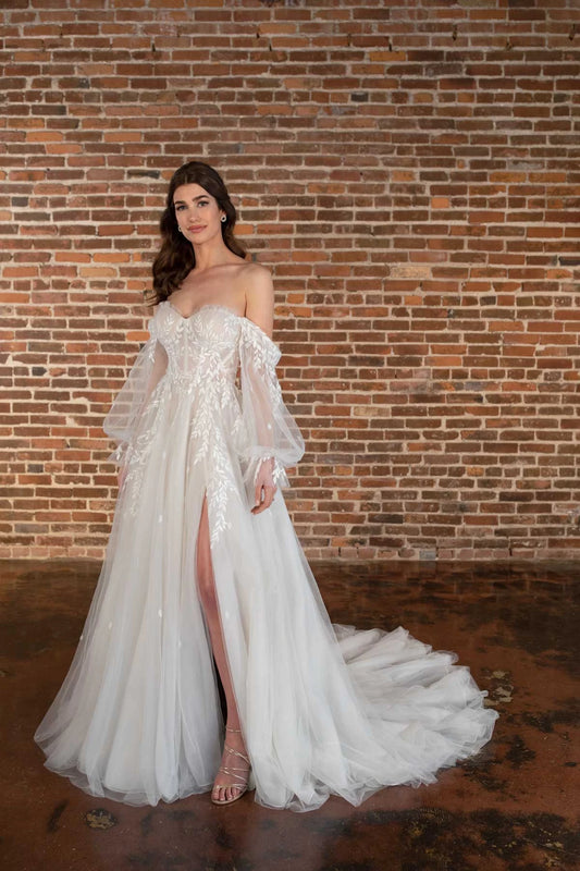Detail of side slit on plus size wedding gown with flowing tulle skirt