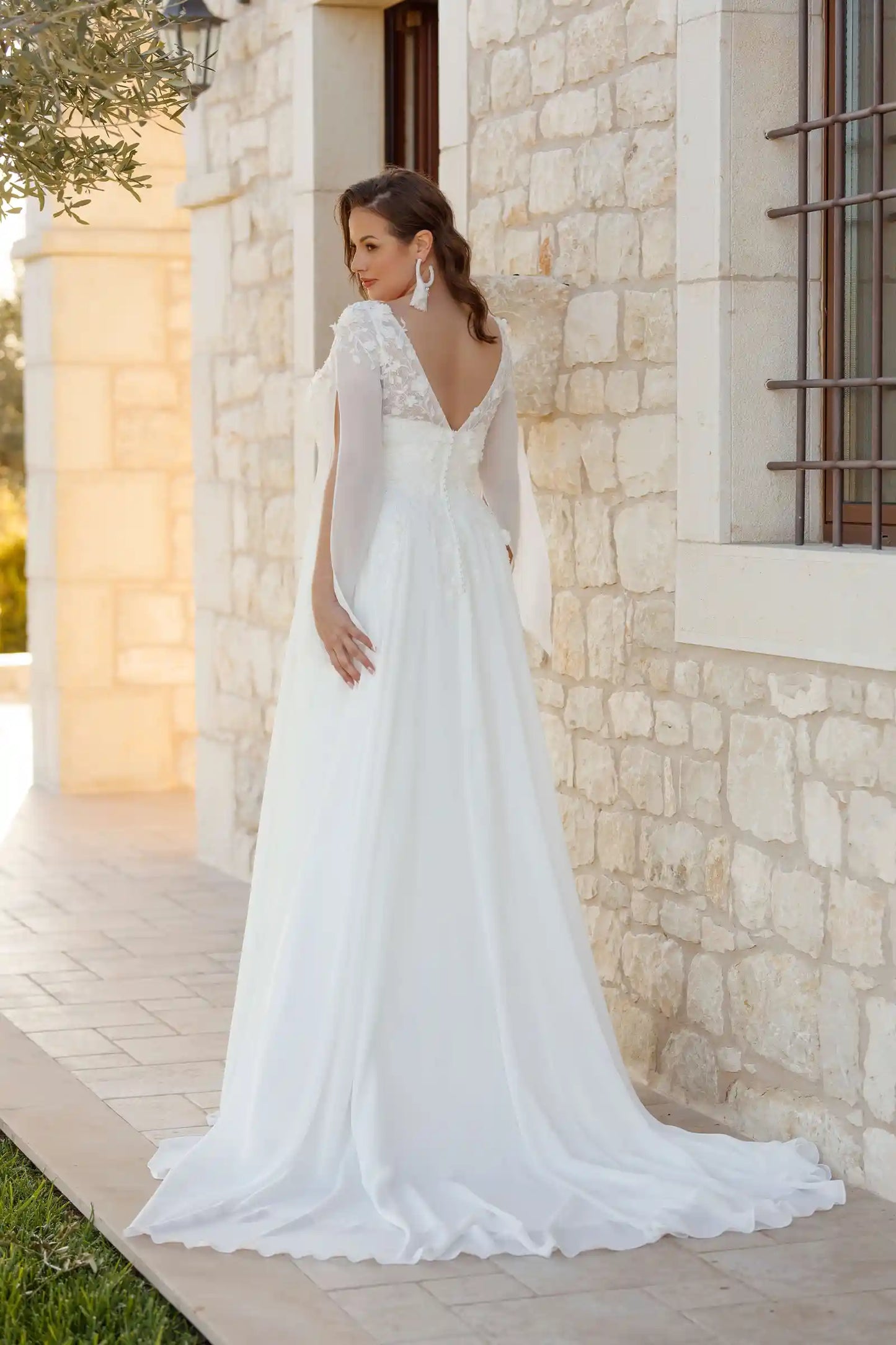Back view of plus size chiffon wedding gown with deep V