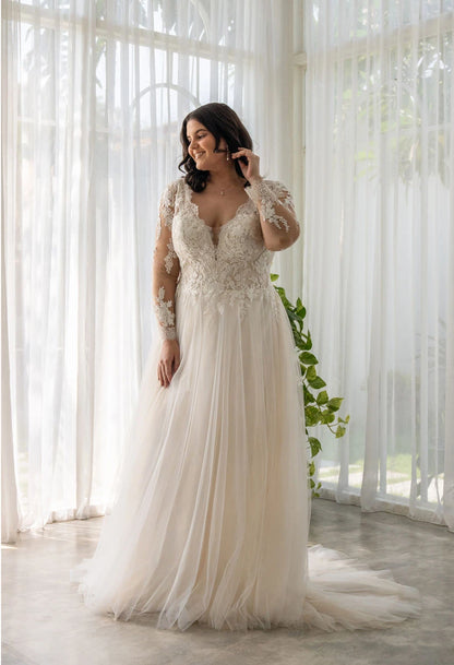 Plus-size wedding dress with lace appliqué bodice, long sheer sleeves, and soft A-line silhouette


