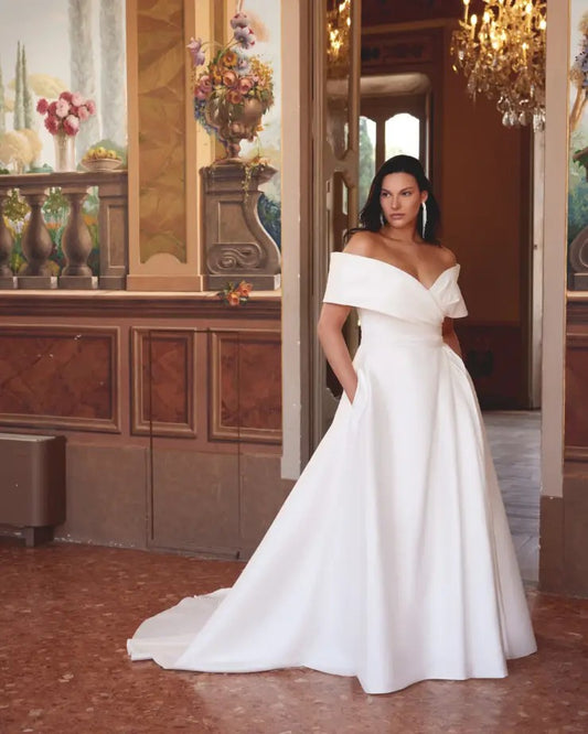 Plus size off-shoulder satin wedding dress with elegant neckline and flowing A-line shape