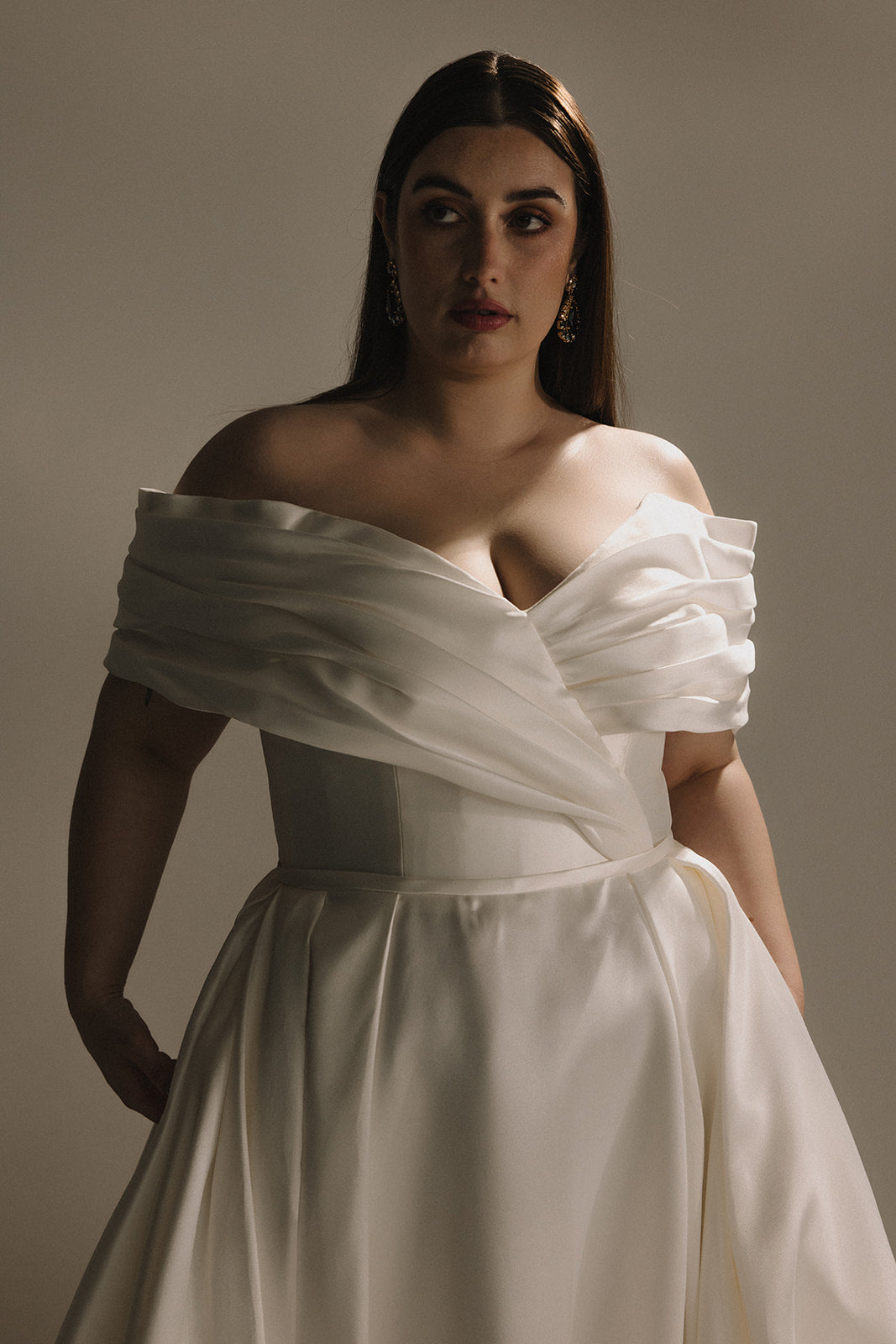 Closeup of V-neck off shoulder satin wedding dress bodice plus size