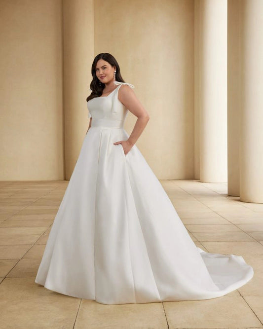 Plus size satin A-line wedding dress with bow shoulder straps and sleek structure