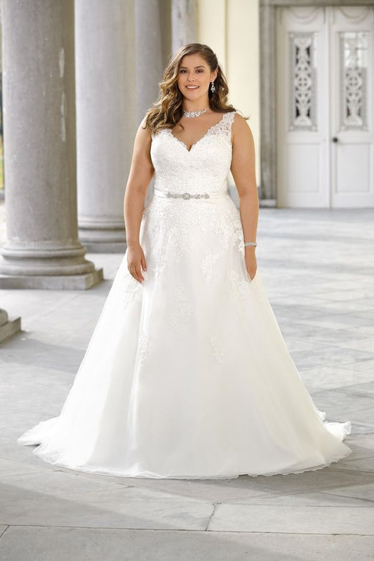 Curvy bride in sleeveless V-neck lace wedding gown