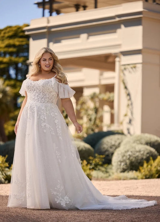 Plus size wedding dress with shiny tulle and lace in outdoor garden