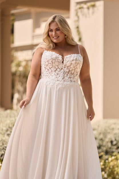romantic a-line bridal gown designed for curvy bride with floral applique

