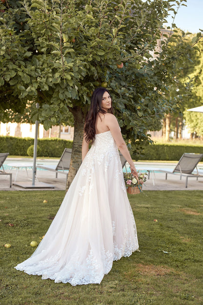 Custom plus-size wedding gown with soft lace, strapless design, and dreamy tulle skirt