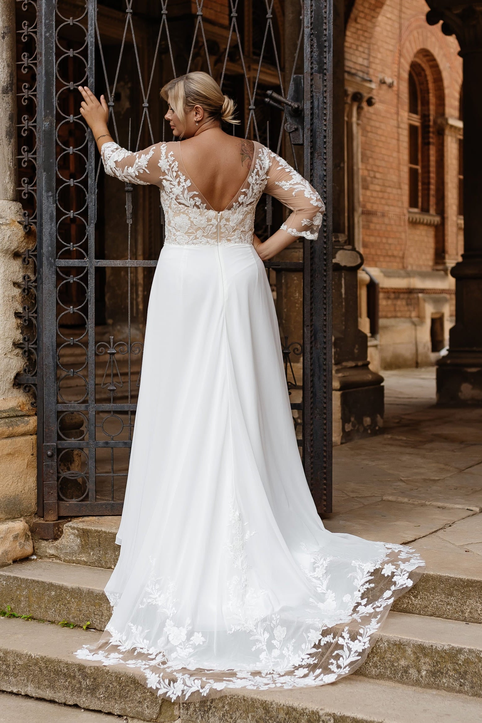 Gown with romantic sheer lace sleeves and delicate floral embroidery for curvy brides