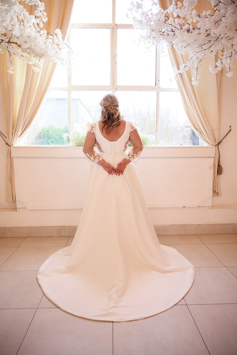 Satin A-line bridal gown with V-neckline and vintage lace details for fuller figures

