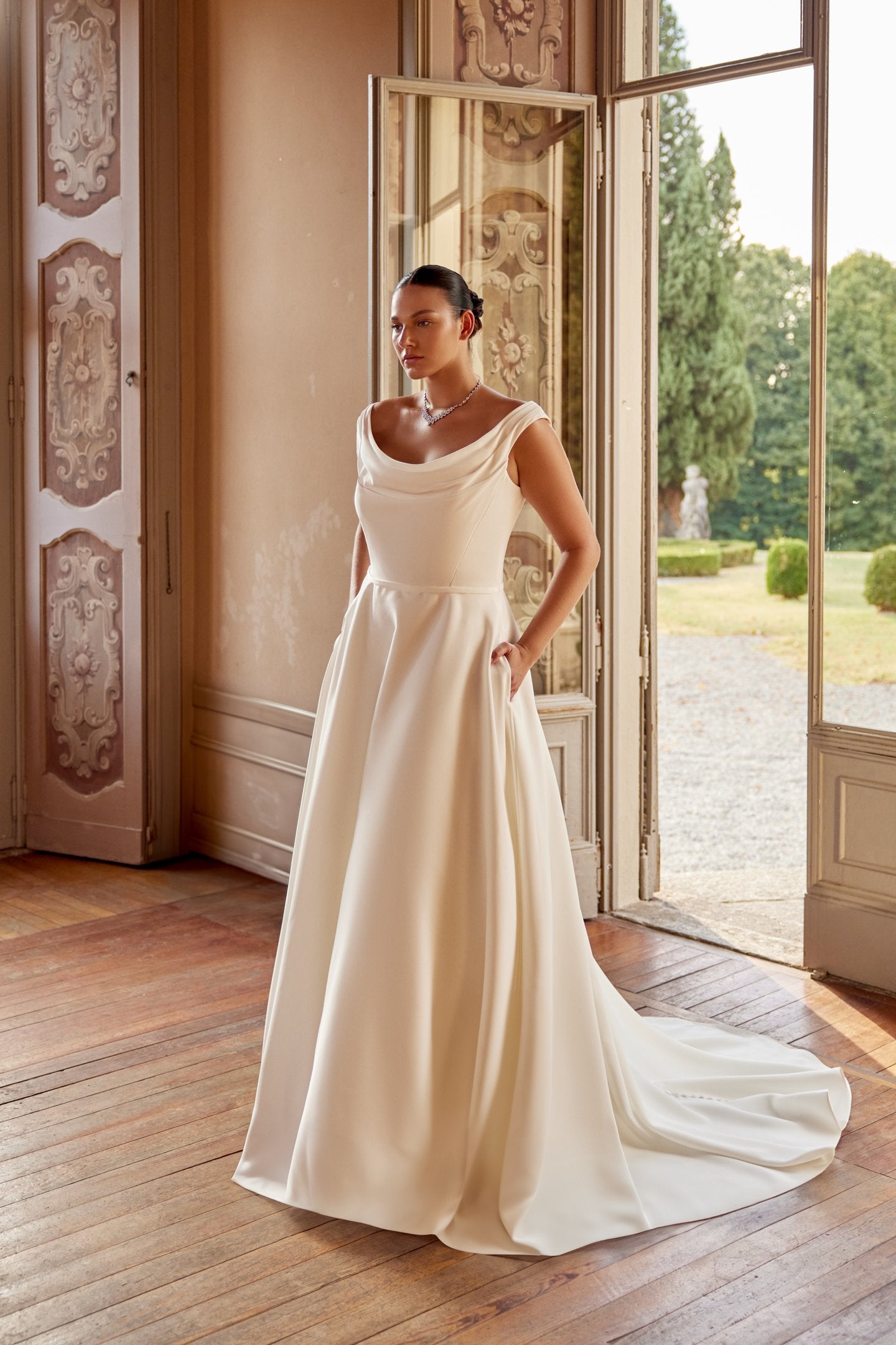 Elegant plus size bridal dress with soft draped scoop neck and satin fabric