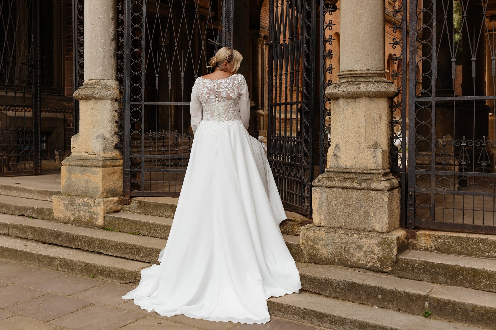 Plus size bridal gown with flowing chiffon and sweep train