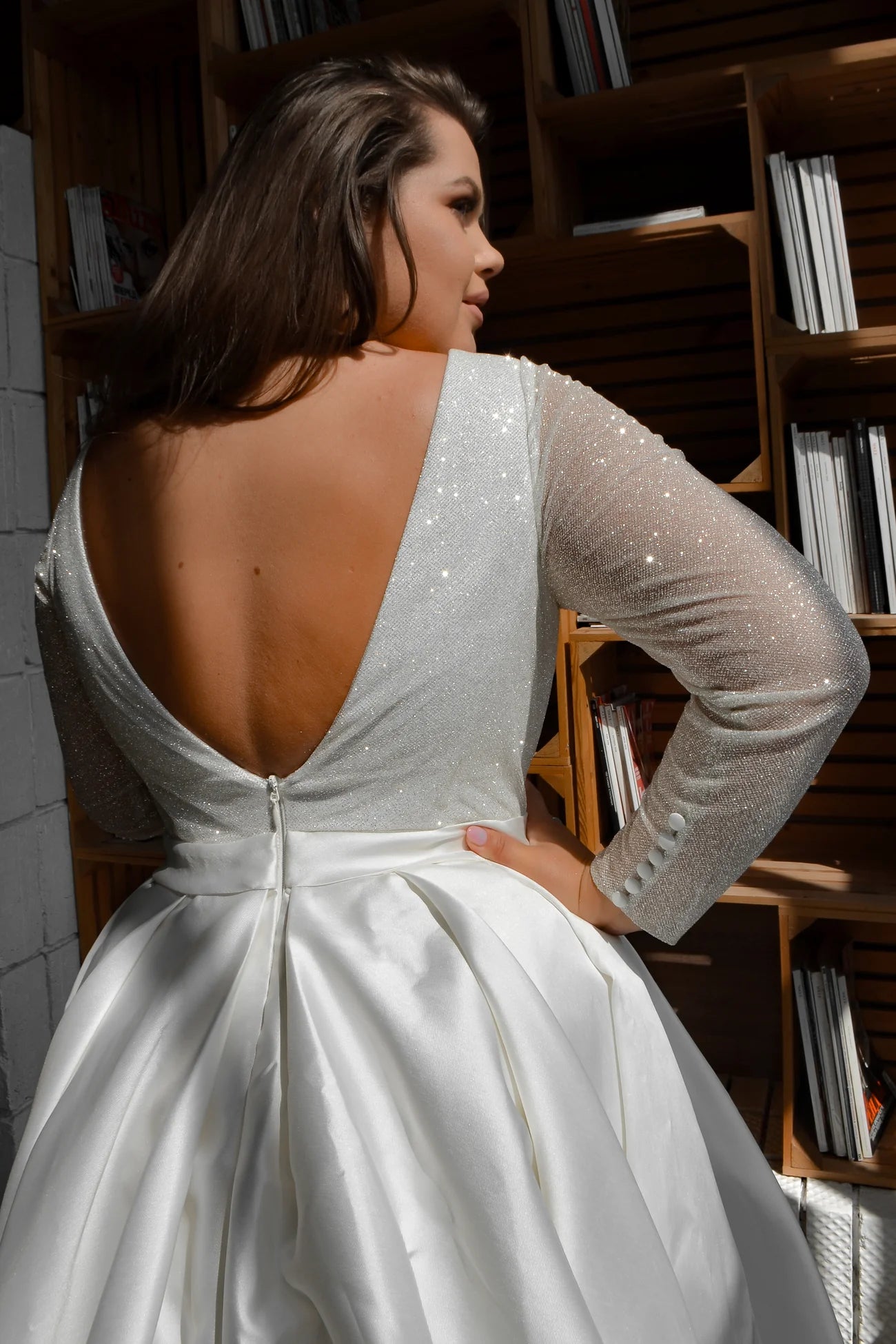 Side view of sparkling plus size wedding gown with V-neck and flowing skirt