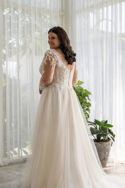 Lightweight tulle A-line gown for plus-size bride with flowing movement and flattering waist

