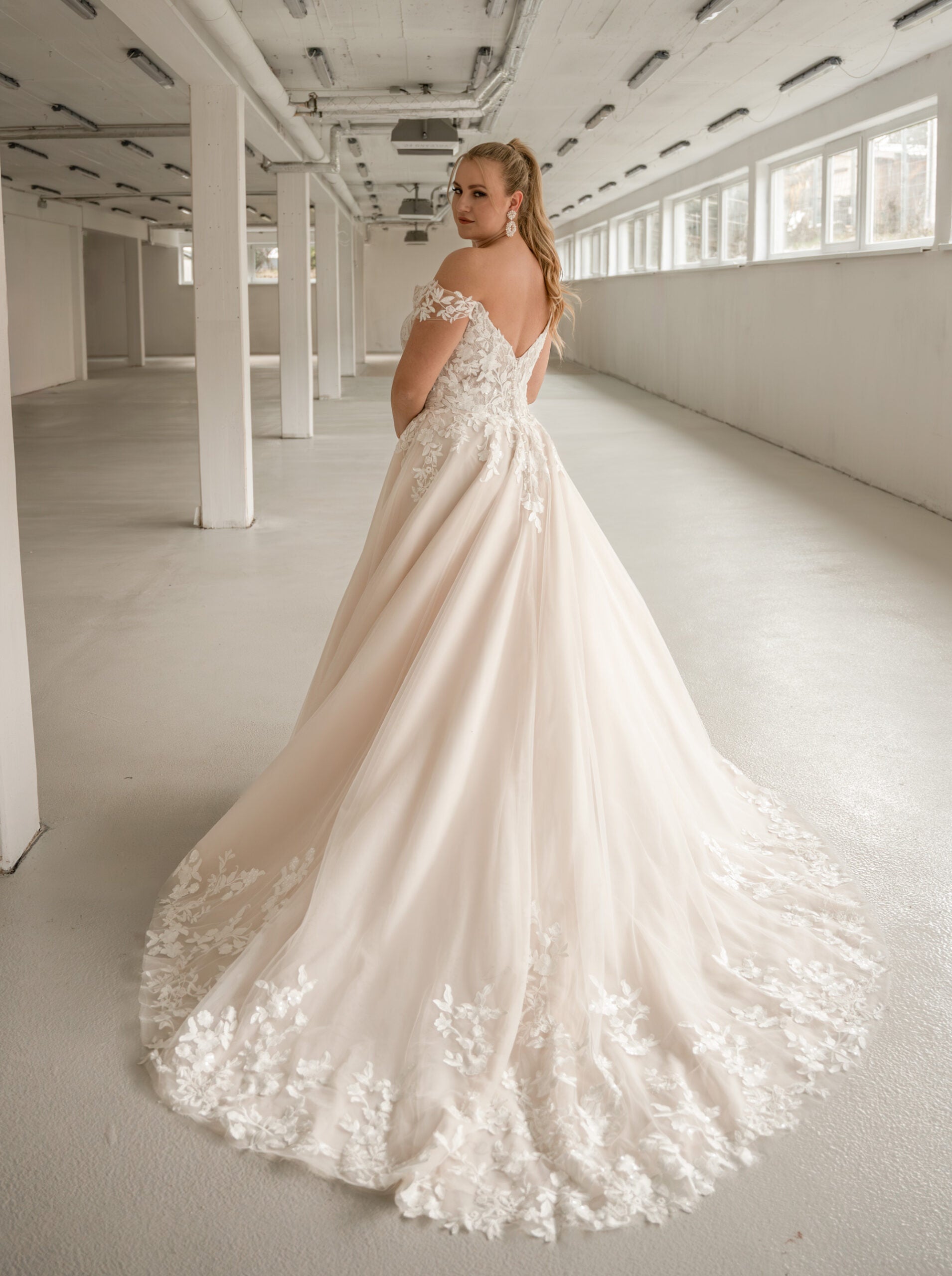 Plus size wedding dress with V-neckline and off-shoulder straps